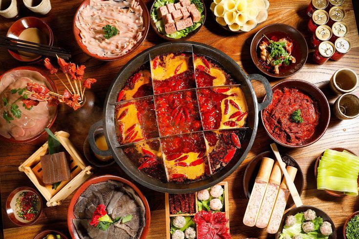 a table topped with lots of different types of food and bowls filled with sauces