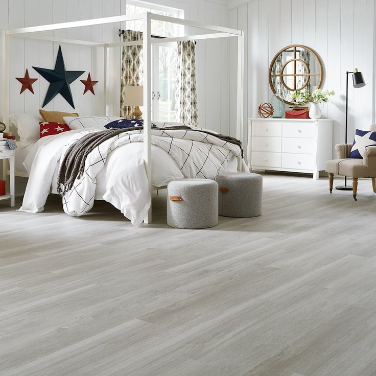 a bedroom with white walls and wood flooring is decorated in patriotic colors, including stars