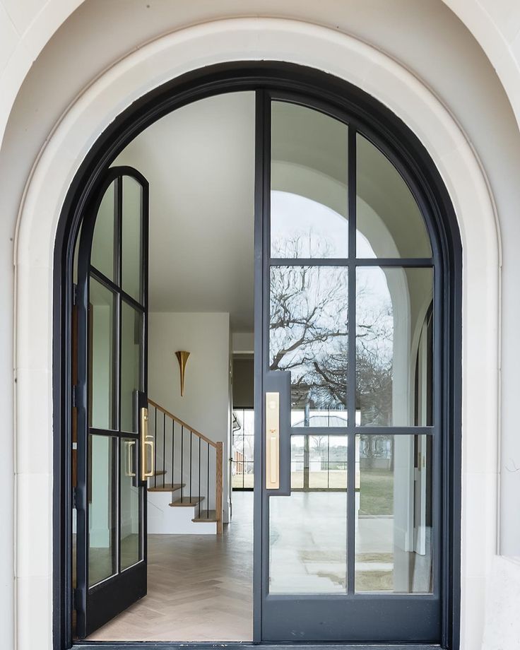 an arched glass door leading to a hallway