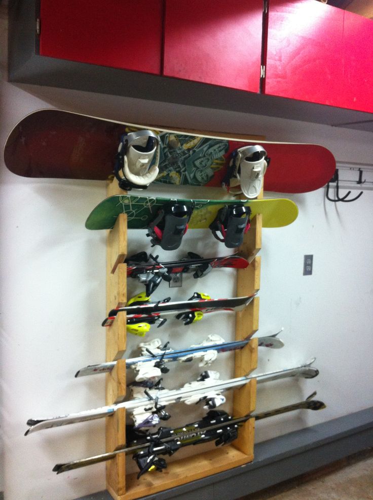 there is a rack with skis and snowboards on it