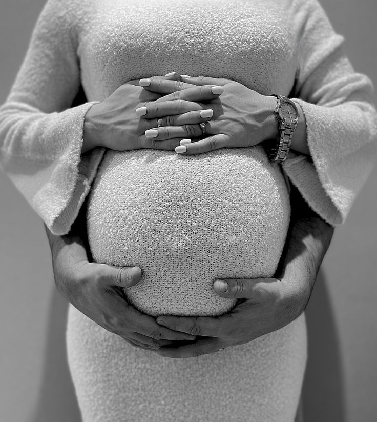 a pregnant woman with her hands on the belly