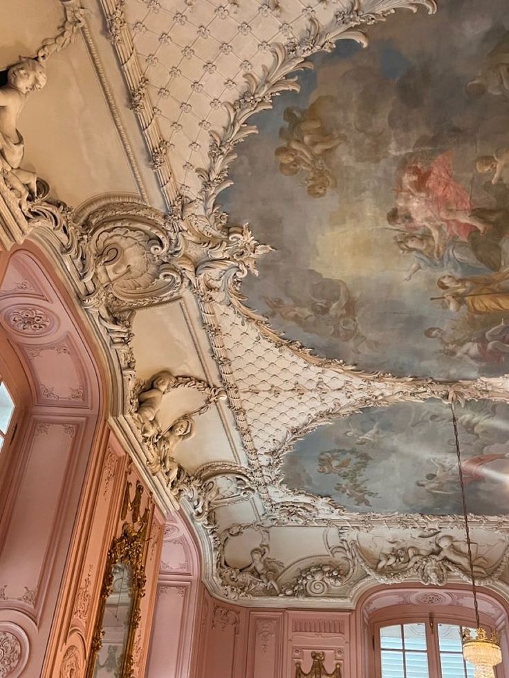 an ornate ceiling with paintings on it in a pink and white room at the palace