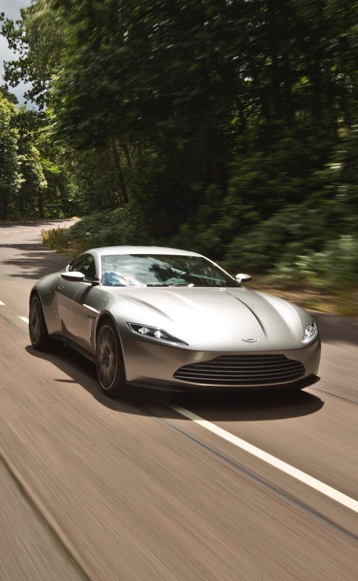 a silver sports car driving down the road