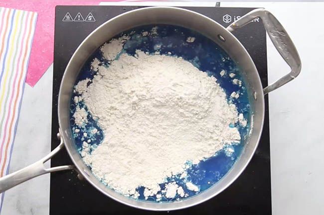 a pan filled with white powder sitting on top of a stove