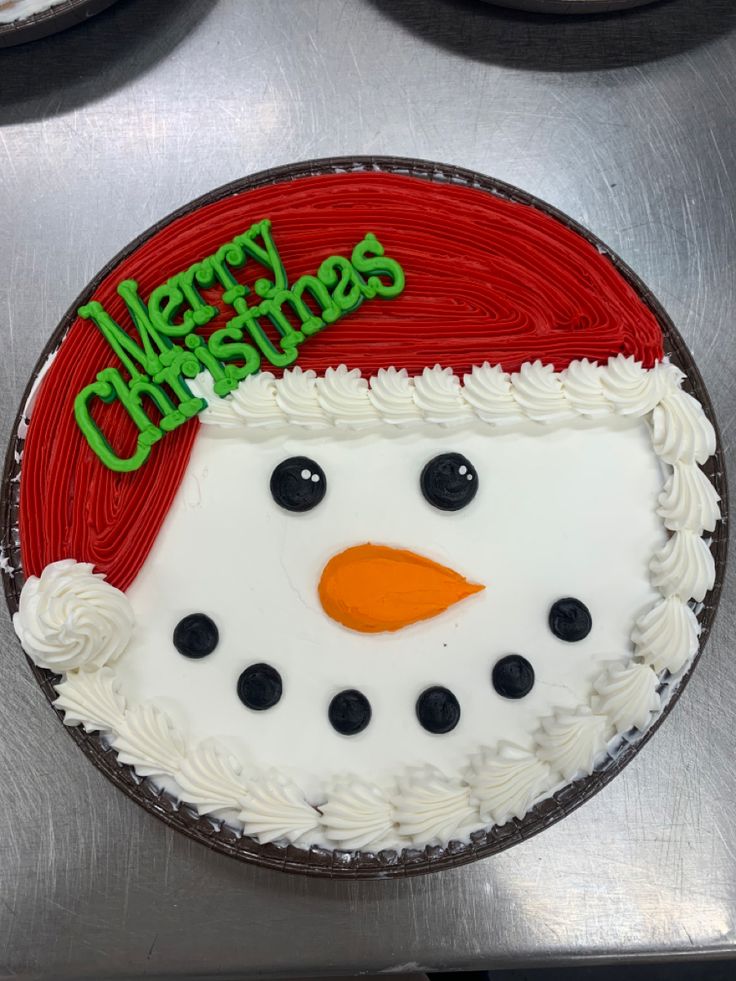 a frosted cake decorated with a snowman's head