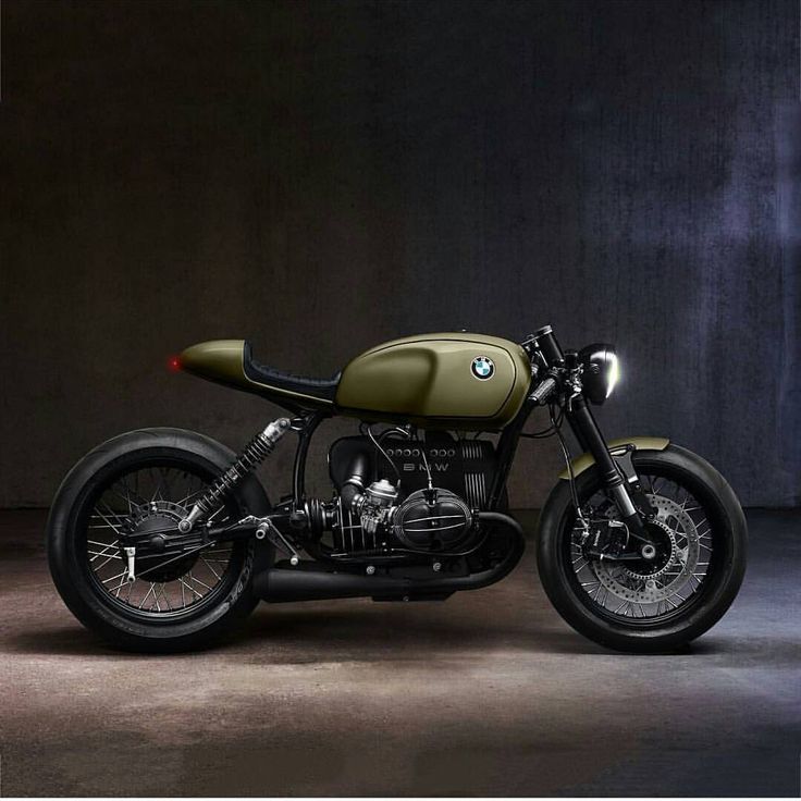 a green motorcycle parked in a dark room