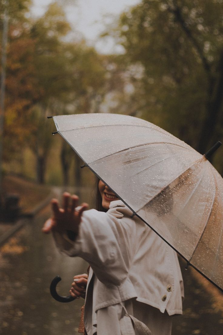 a woman holding an umbrella in the rain