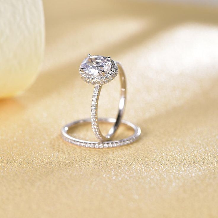 a diamond ring sitting on top of a table