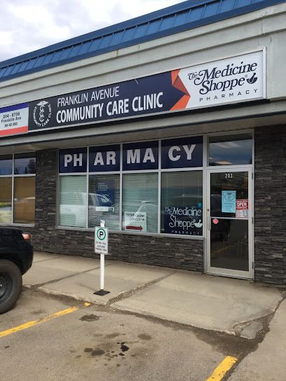 the front of a pharmacy store with cars parked outside