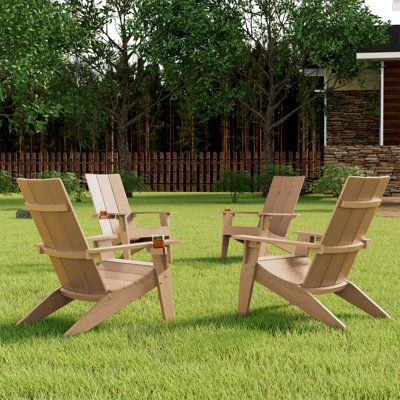 three wooden lawn chairs sitting in the grass