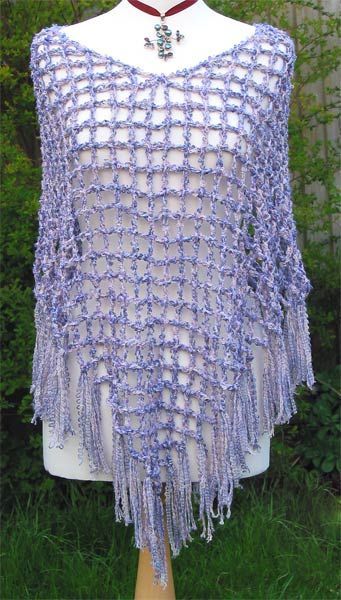 a purple crocheted shawl on top of a mannequin