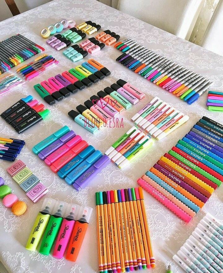 the table is covered with many different colored pencils