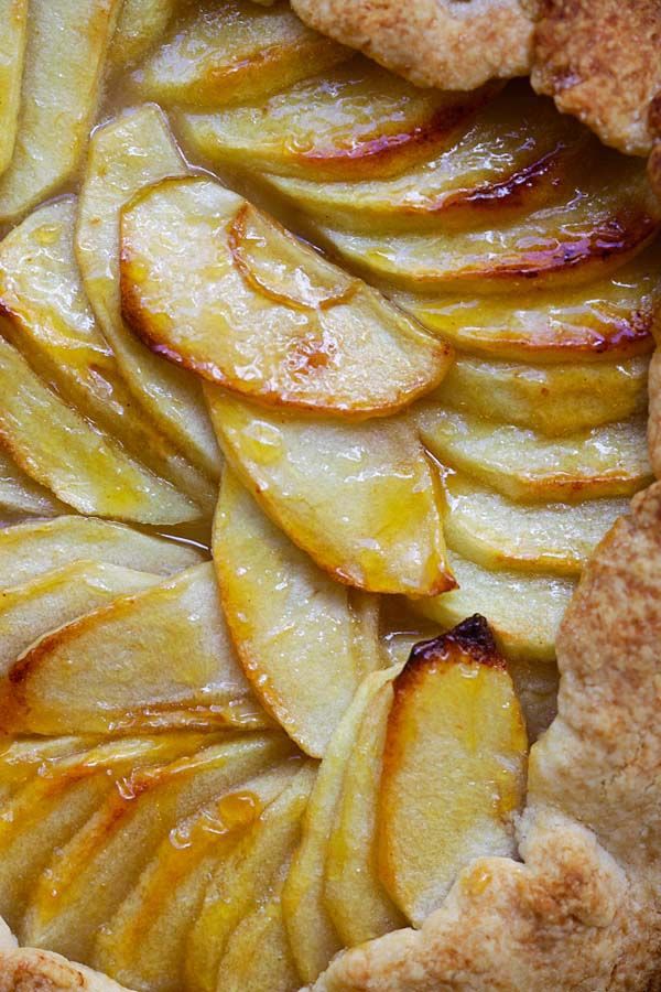 an apple pie with slices cut out and ready to be eaten