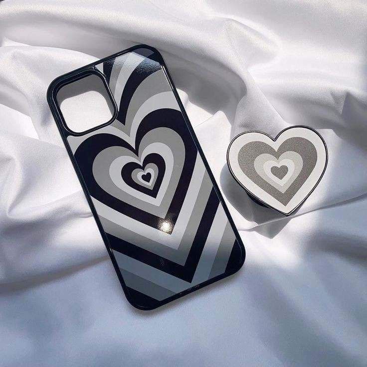 an iphone case with two hearts on it next to a heart shaped object in the shape of a box