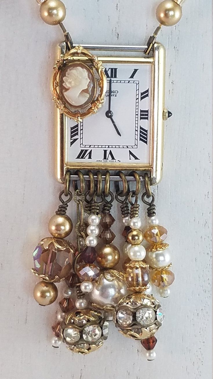 a close up of a clock on a wall with beads