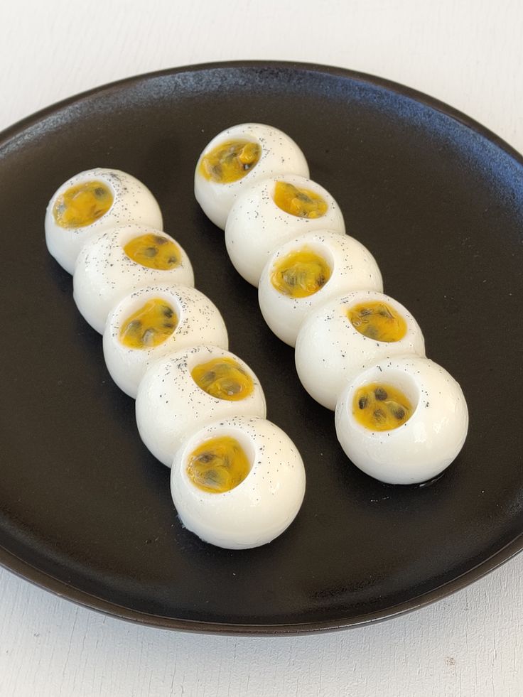 an image of deviled eggs on a black plate