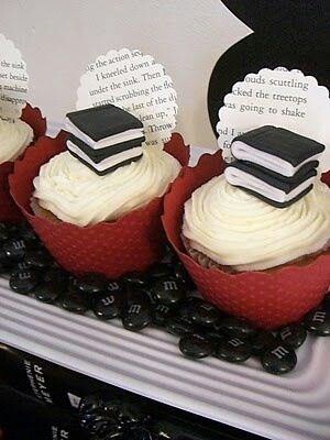 some cupcakes with books on top of them