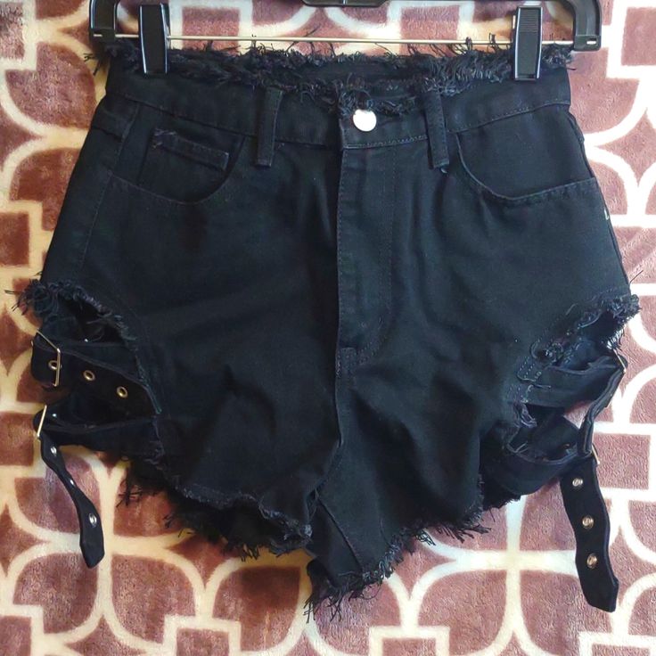 Nwot Women's Sexy/Punk Style High Waisted Black Jean Factory Distressed Cheeky Shorts. Frayed On Top And Frayed On Bottom Of Leg And Back Pockets 2 Adjustable Buckle Straps On Each Side Of Leg. Bought From (Shein) But Never Wore Them. Size: Xsmall Fits Like A Small Waist: 13" Flat Rise: 9" Flat Perfect Condition Comes From Smoking And Pet Free Home All Pre-Owned Items Are Dry-Cleaned Before Shipped Out Come Check Out My Other Listings In My Closet And Bundle And Save Black Grunge Shorts For Alternative Fashion, Black Grunge Shorts For Grunge Fashion, Trendy High Waist Shorts For Alternative Fashion, Trendy High-waist Shorts For Alternative Fashion, High Waist Punk Shorts For Alternative Fashion, Punk Style Bottoms For Summer Concerts, Summer Punk Bottoms For Concerts, Alternative Style Bottoms For Summer Concerts, Alternative Style Summer Bottoms For Concerts