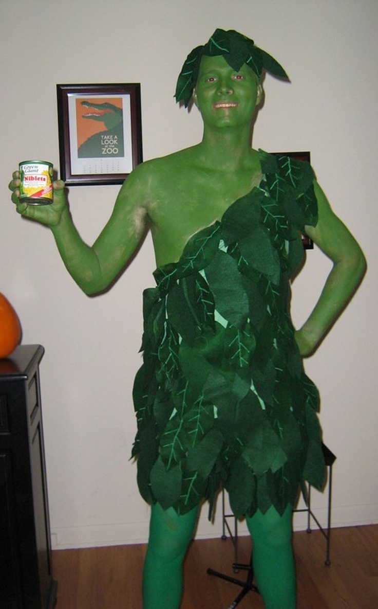 a man dressed in green is holding a canned drink