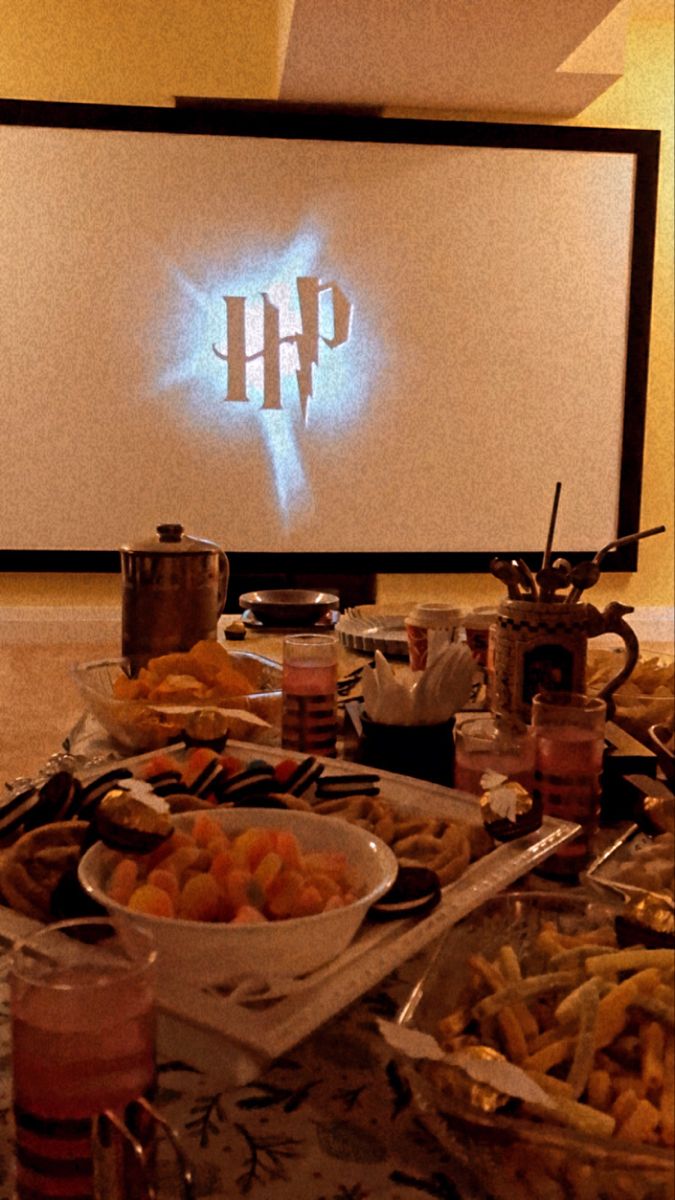 a table full of food in front of a projector screen with the word hp on it