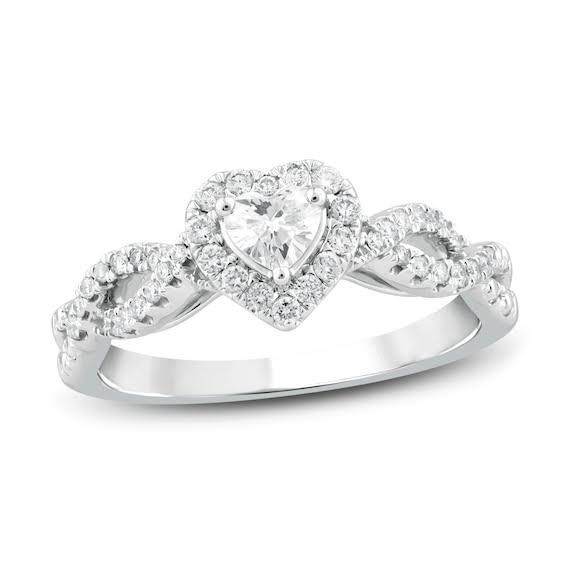 a heart shaped diamond ring with diamonds on it