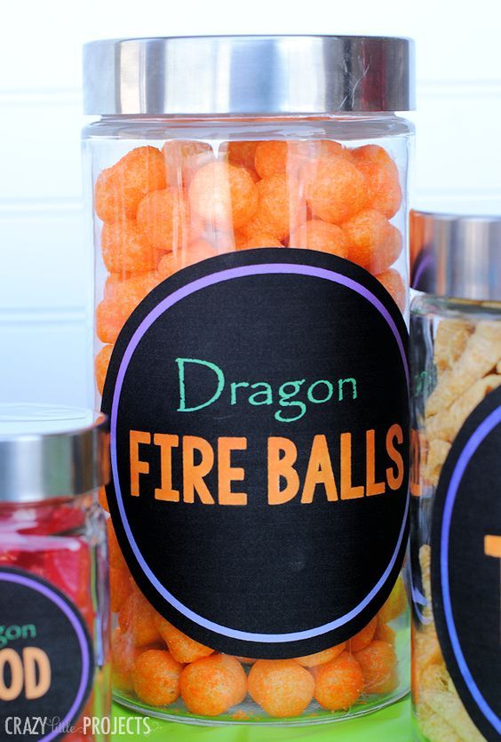 three jars filled with orange and black fire balls