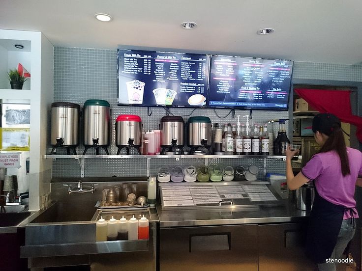 a woman standing in front of a metal counter