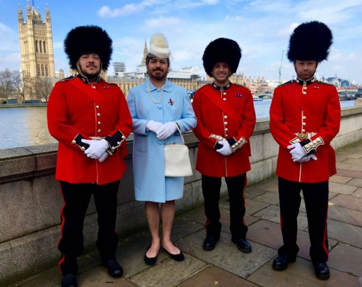 three men in red uniforms standing next to each other with the big ben in the background