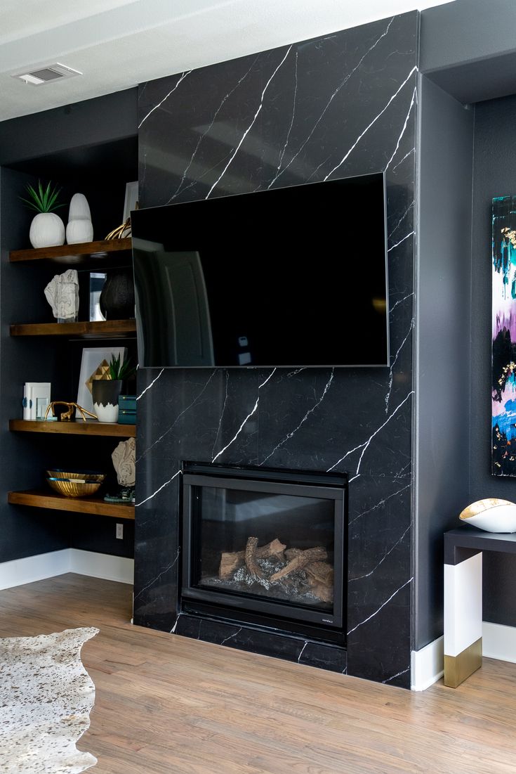 a living room with a fireplace and television mounted on the wall