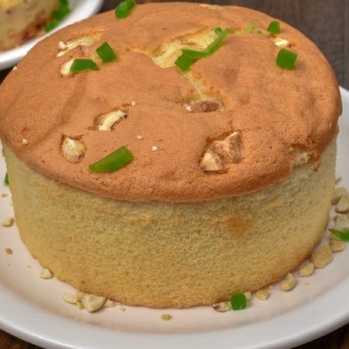 a cake on a plate with green onions