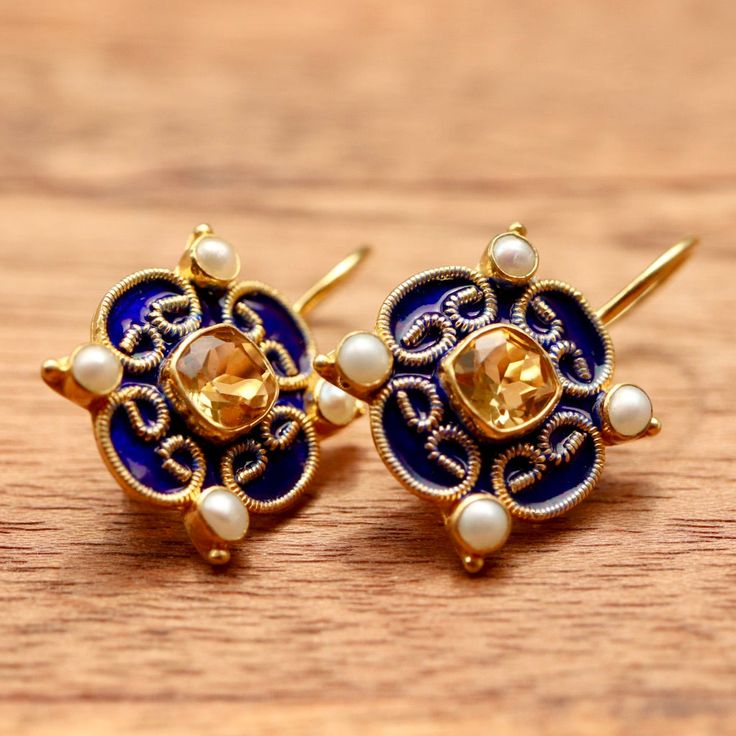 An artistically important creation. Royal blue enamel and golden filigree make a regal setting for radiant citrine or cubic zirconia paired with cultured pearls. Hand crafted of 24k gold over sterling silver; European backs. Size 1 Inch. Ornate Yellow Gold Meenakari Earrings, Ornate Yellow Gold Earrings With Meenakari, Elegant Enamel Earrings With Gemstones, Elegant Gemstone Earrings With Enamel, Elegant 22k Gold Gemstone Earrings, Yellow Round Meenakari Jewelry, Meenakari Yellow Gold Drop Earrings, Elegant Ceremonial Gemstone Earrings, Elegant Gemstone Ceremonial Earrings