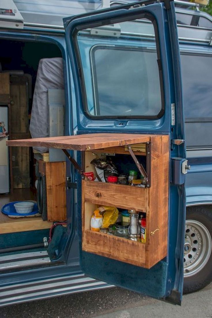 an open blue van door with food and drinks in it