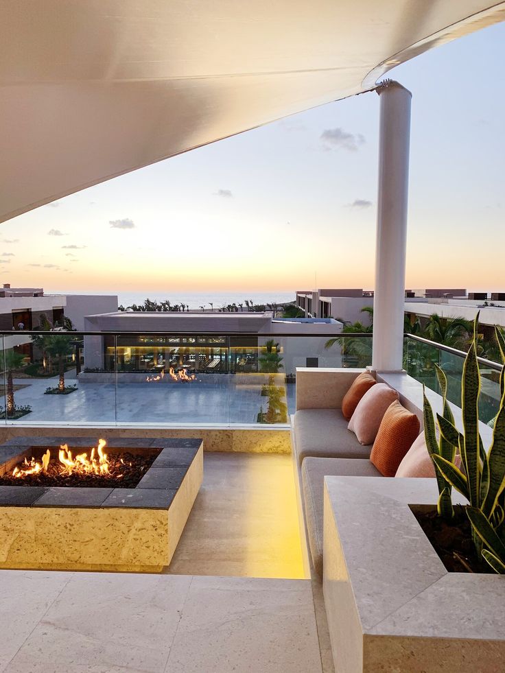 an outdoor fire pit sitting on top of a patio