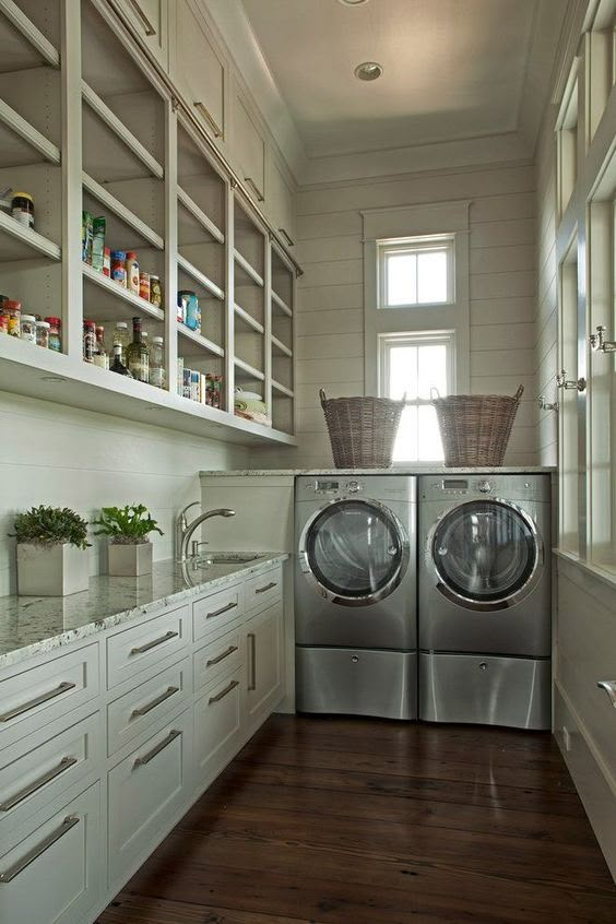 a washer and dryer sitting in a kitchen next to cabinets with open shelving