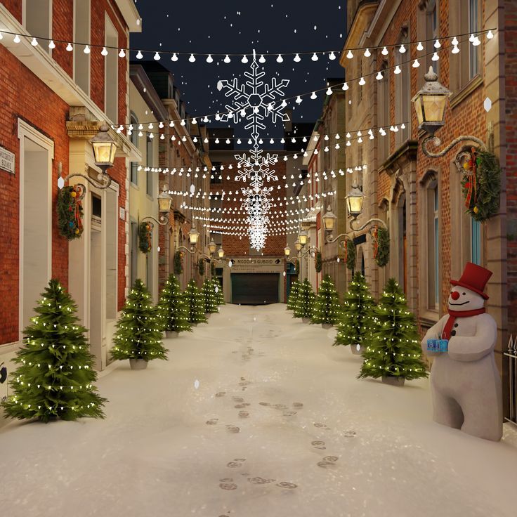 a snowman is standing in the middle of a snowy street with christmas lights strung across it