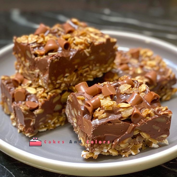 three pieces of chocolate peanut butter granola bars on a plate