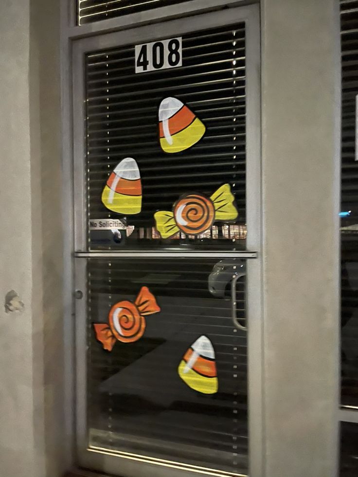 the window is decorated with candy corn and lollipops