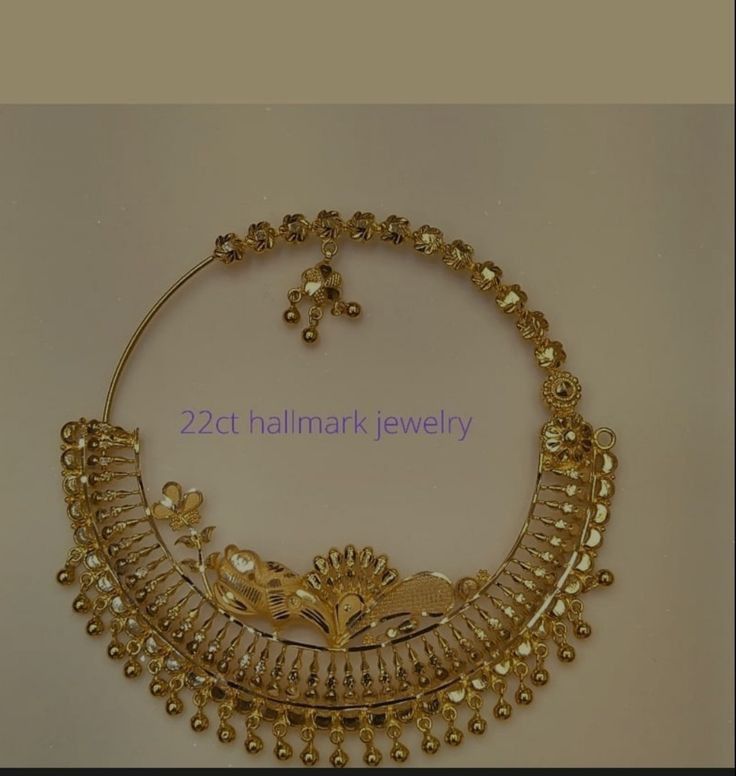 a gold necklace and earring set with pearls on the bottom, is shown in this image