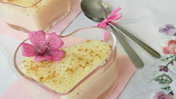 two desserts with pink flowers and spoon on the table