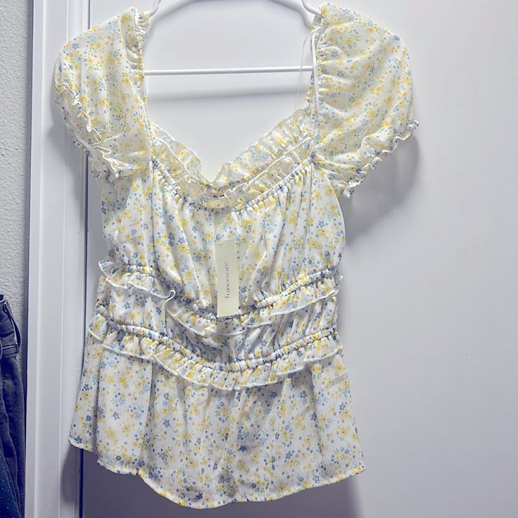 Medium Sized Blouse From Francesca’s. White With Blue, Yellow And Green Floral Pattern. New With Tags, Originally $34. Feminine Yellow V-neck Blouse, Yellow Feminine Blouse, Yellow Feminine Blouse For Daywear, Feminine Yellow Blouse For Daywear, Feminine Yellow Blouse For Day Out, Feminine Fitted Yellow Blouse, Feminine Yellow Blouse For Brunch, Yellow Ruffled Top For Brunch, Yellow Floral Print Top For Daywear