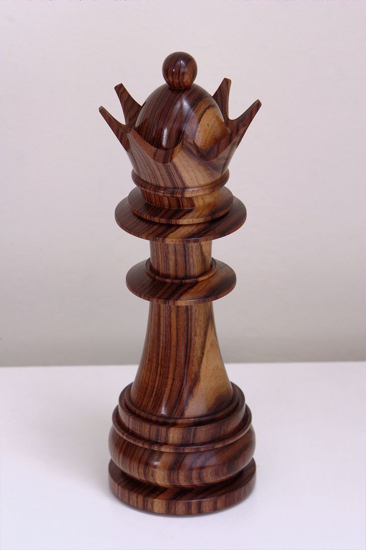 a wooden chess piece with a crown on top