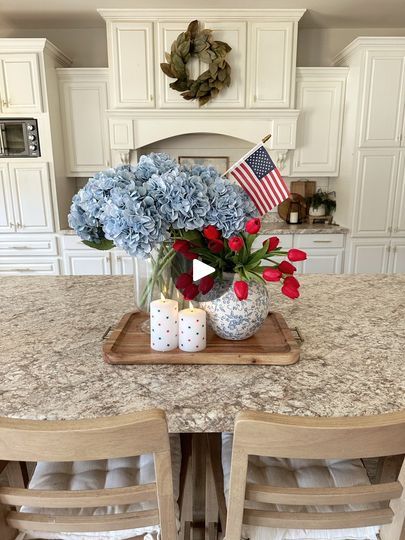 a kitchen table with flowers and candles on it