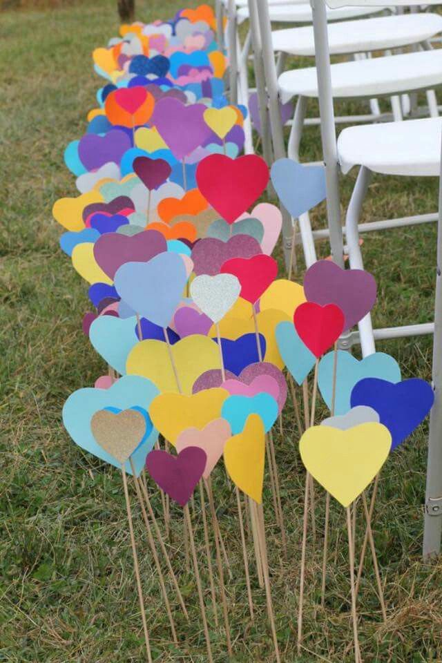 rows of chairs lined up with heart shaped picks in the shape of hearts on them