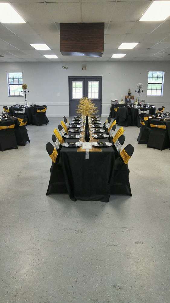 an empty banquet room with black and yellow tablecloths