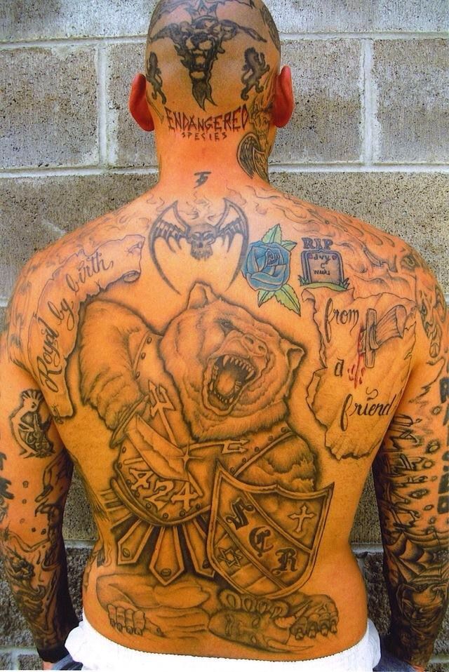 a man with many tattoos on his back