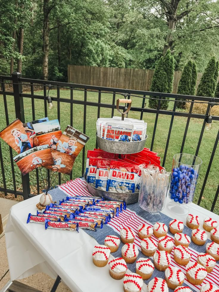 a table topped with cupcakes covered in red, white and blue frosting