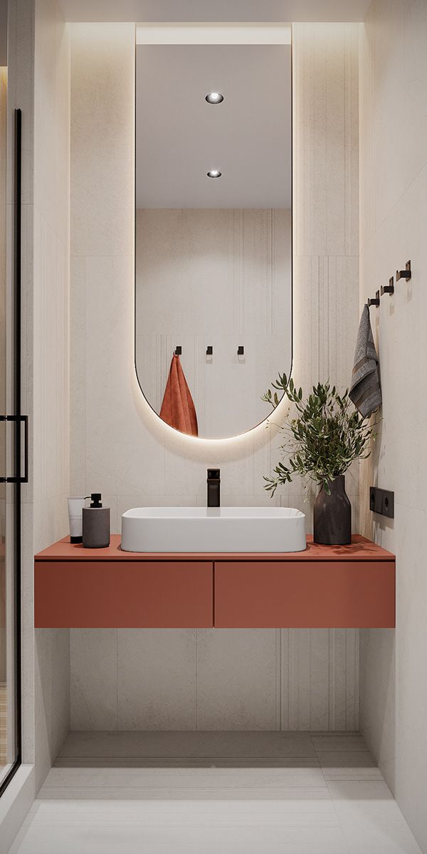 a bathroom with a sink, mirror and plants on the counter top in front of it