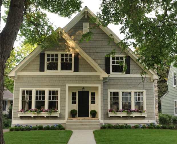 a gray house with white trim and black shutters