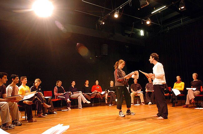 two people standing on a stage in front of an audience