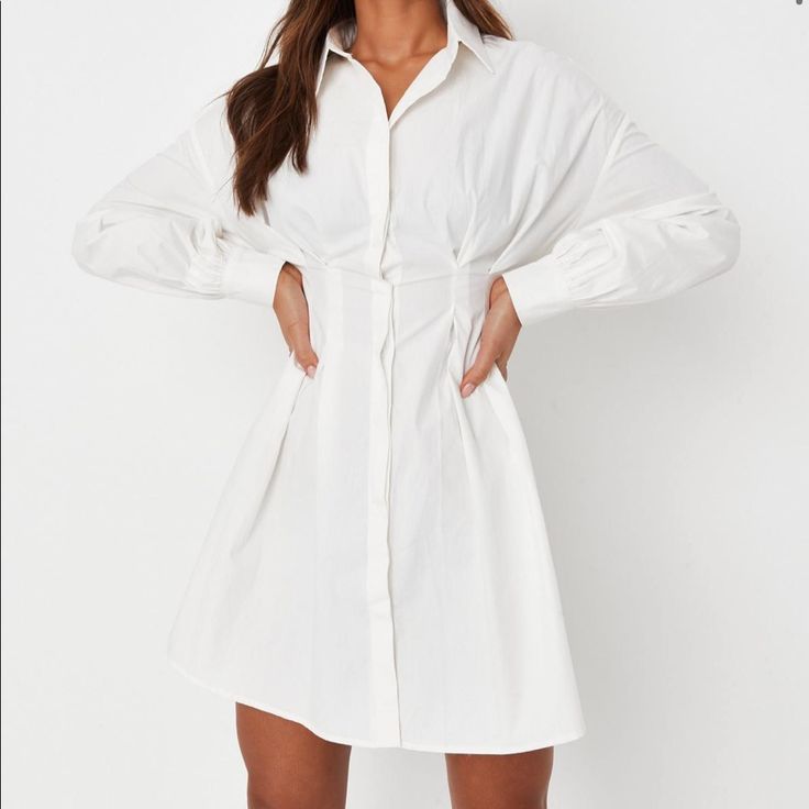 White Poplin Pleated Waist Shirt Dress Shirt Dress With Drop Shoulder Seams, Pleated Waist And Concealed Button Front. Regular Fit Mini - Sits Mid Thigh 100% Cotton White Pleated Shirt Dress For Work, Long Sleeve White Shirt Dress With Buttons, White Long Sleeve Shirt Dress With Buttons, White Long Sleeve Shirt Dress With Button Closure, White Fitted Pleated Shirt Dress, White Buttoned Shirt Dress For Work, White Mini Shirt Dress For Workwear, White Button Closure Shirt Dress For Work, White Button-up Shirt Dress For Work